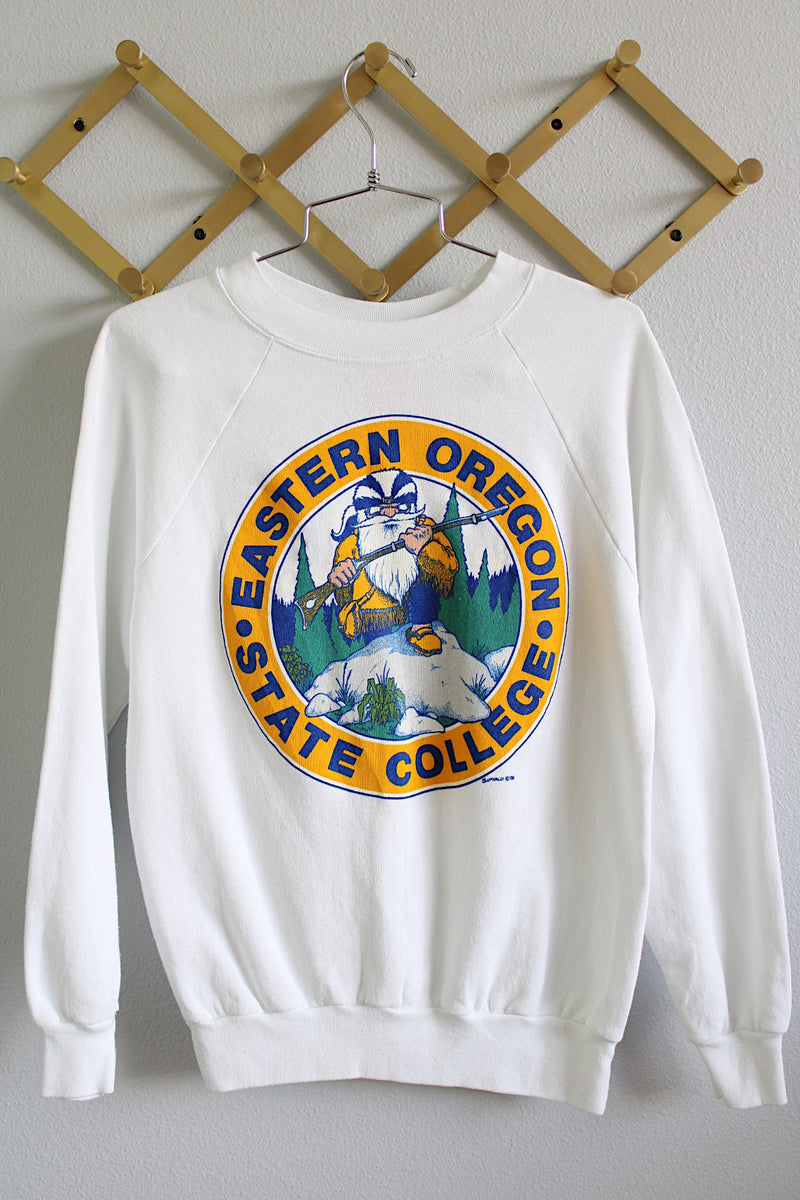 Women's or men's vintage 1980's Buffalo, Made in USA label long sleeve white crew neck pullover sweater in a polyester cotton blend material.