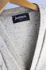 Men's or women's vintage 1970's Jantzen, Made in USA label sleeveless button up sweater vest cardigan in a wool and acrylic material. Oatmeal color with navy speckles and a cable knit texture. 