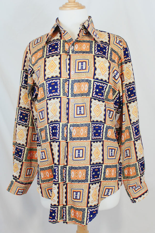Men's vintage 1970's Envoy label long sleeve button up shirt with dagger collar with all over orange and navy abstract print. 