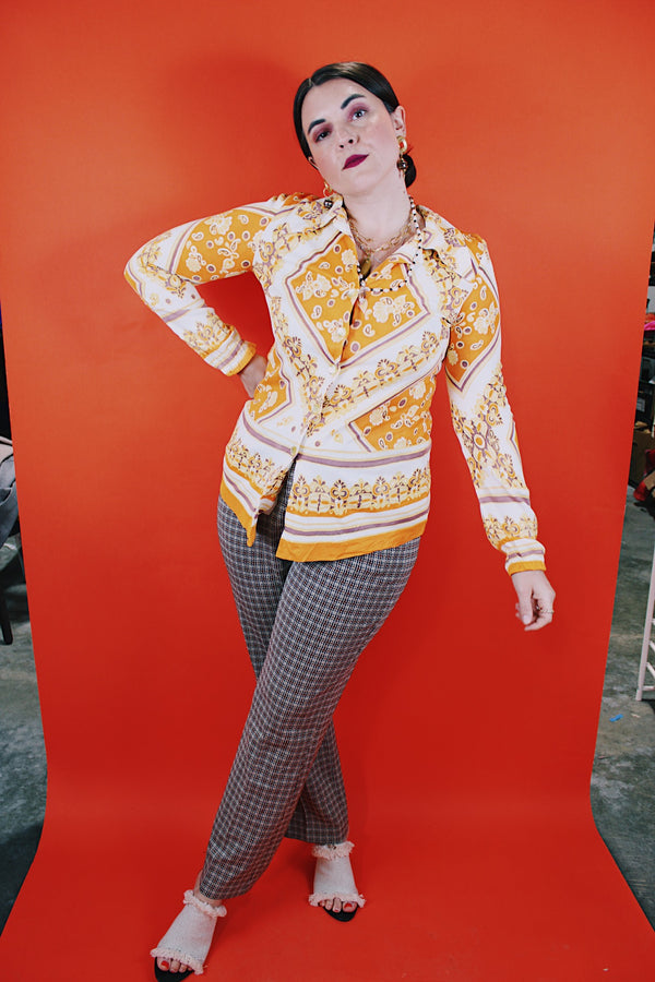 Women's vintage 1970's long sleeve button up blouse with dagger collar, darted bust, and big round clear buttons.