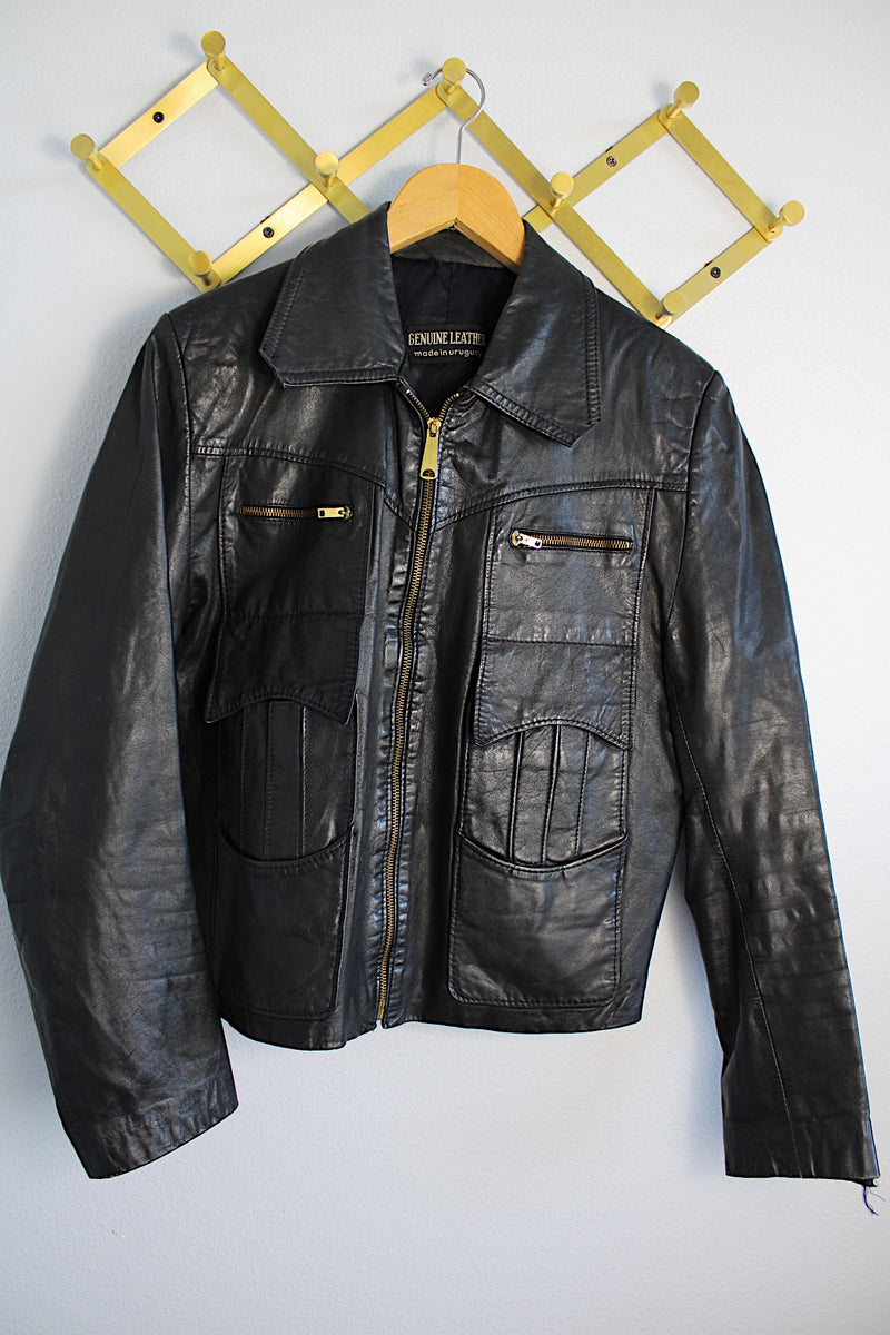 Women's or men's vintage 1970's Genuine Leather, Made in Uruguay long sleeve zip up black leather jacket with brass zippers and four front pockets