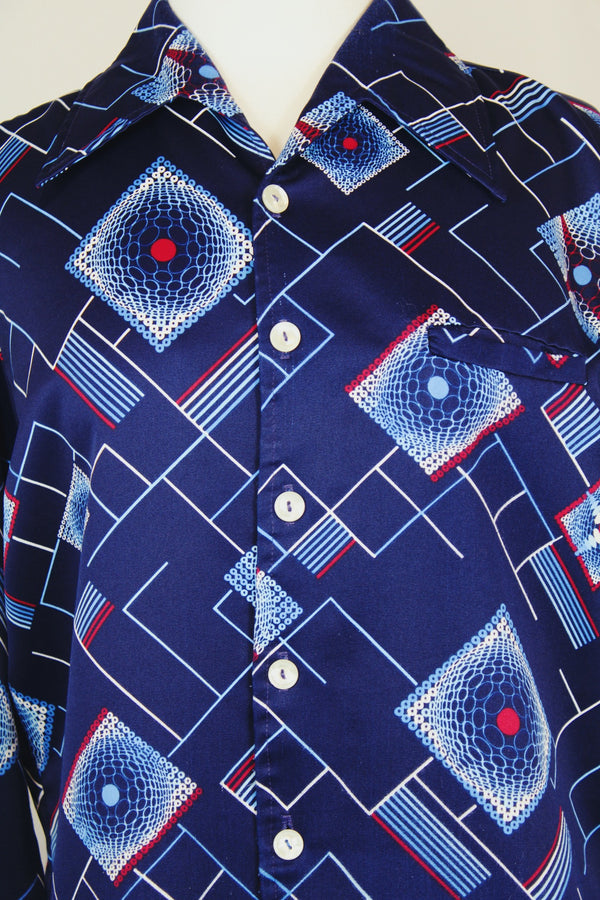 Men's vintage 1970's Da Vinci Presents Delfina label long sleeve vibrant navy blue button up shirt with all over white and red abstract print in thick polyester material. 