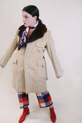 Men's or women's vintage 1970's tan suede long length long arm jacket with brown fur trim around collar. Matching suede belt. 
