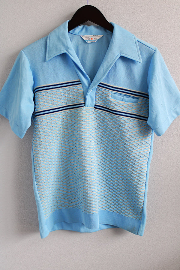 Men's or women's vintage 1970's Styled in California for JCPenney label short sleeve polo top in a light blue polyester material. Has a collar and half button closure.