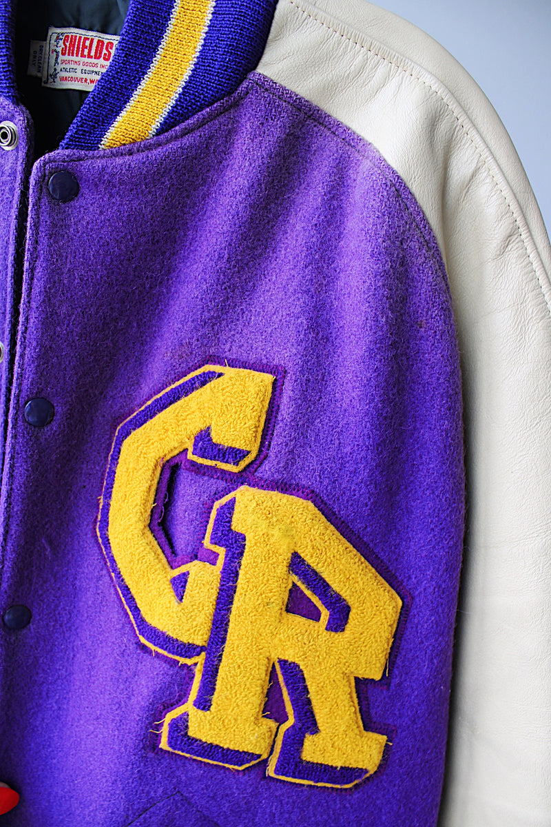 Women's or men's vintage 1960's Shields, Sporting Goods Inc., Vancouver, Washington label long sleeve wool and leather varsity letterman jacket in purple, cream, and yellow colors. 