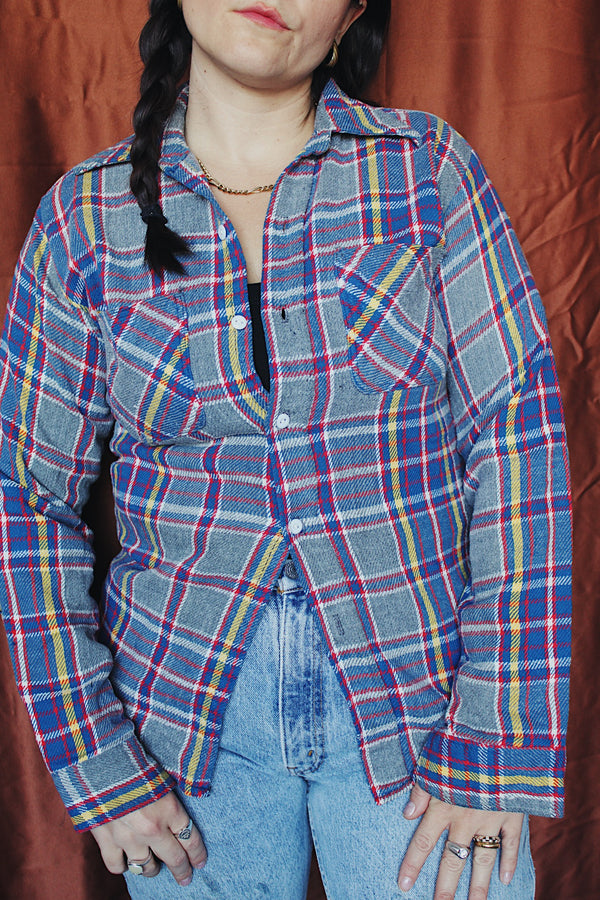 Men's or women's vintage 1970's Big Mac label long sleeve plaid button up flannel shirt in blue, grey, red, and yellow with white buttons.