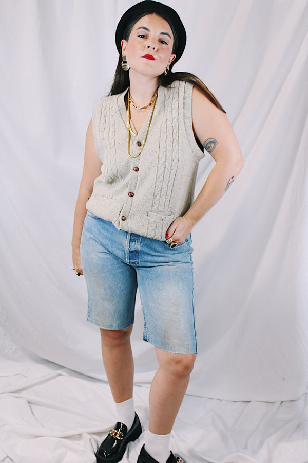 Men's or women's vintage 1970's Jantzen, Made in USA label sleeveless button up sweater vest cardigan in a wool and acrylic material. Oatmeal color with navy speckles and a cable knit texture. 