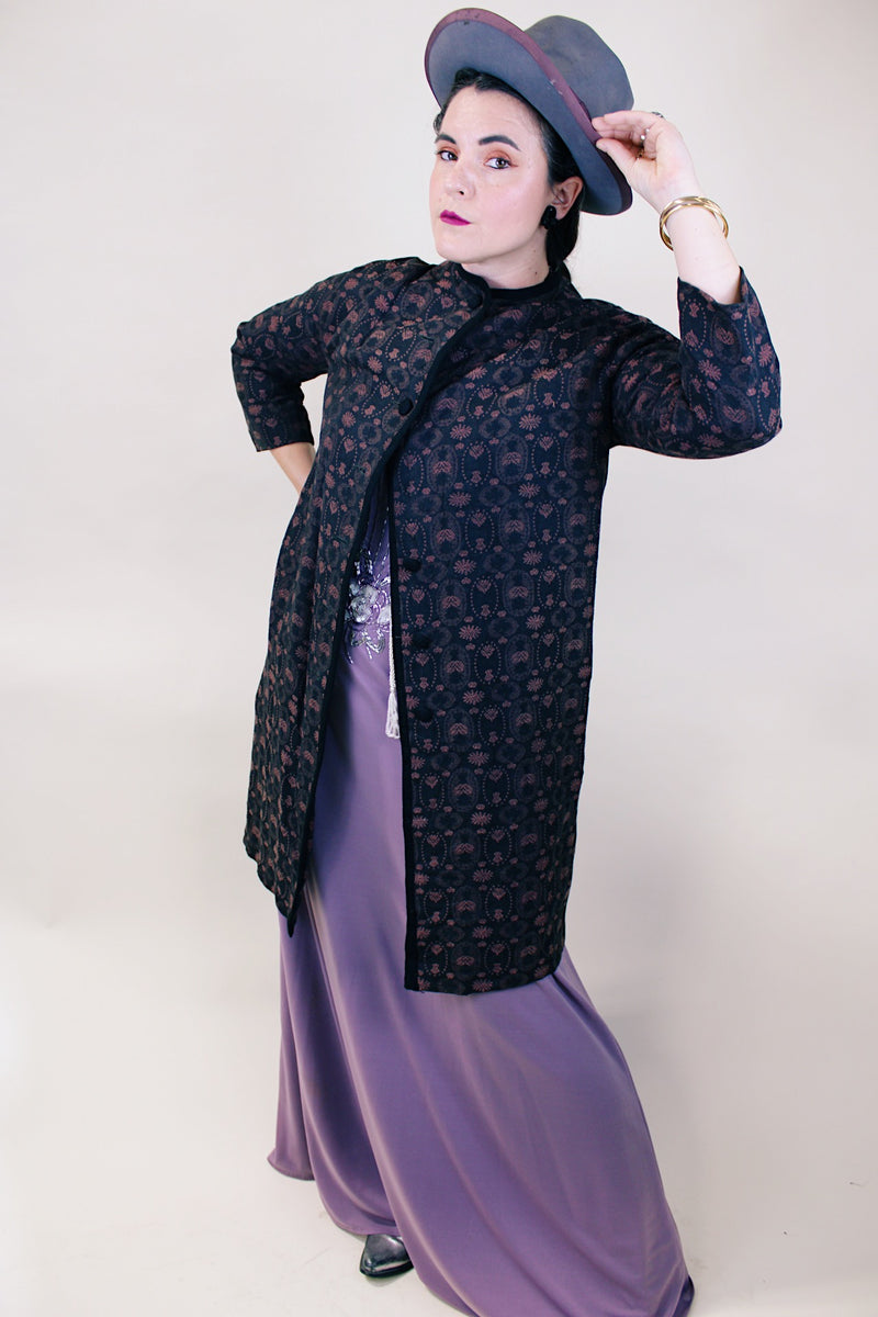 Women's vintage 1960's Helen's Fashion Shoppe, McMinnville, Oregon label long sleeve long length jacket in a black and purple tapestry print.
