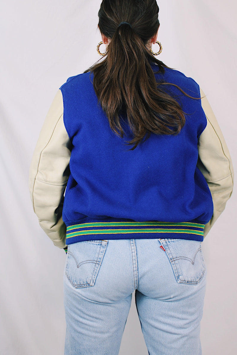 Men's or women's vintage 1970's Dehen, Award Letters, Beaverton, Oregon label long sleeve cream and vibrant blue varsity letterman jacket with green and yellow trim in wool and leather material.
