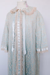 Women's vintage 1970's I. Magnin, Odette Barsa label long length short sleeve baby blue cream lace duster robe jacket with ribbon trim and peter pan collar.
