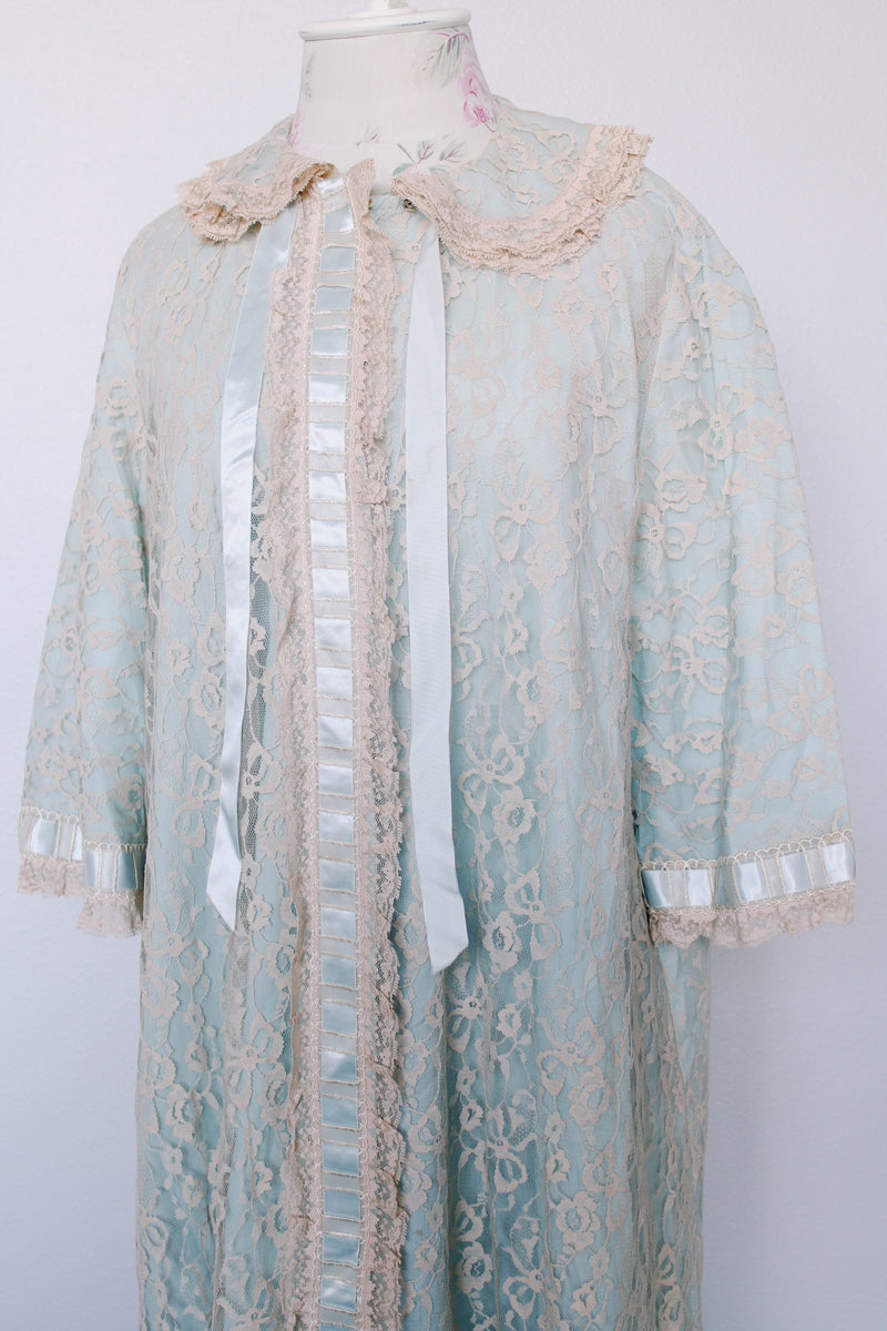 Women's vintage 1970's I. Magnin, Odette Barsa label long length short sleeve baby blue cream lace duster robe jacket with ribbon trim and peter pan collar.