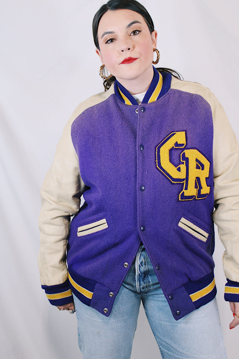 Women's or men's vintage 1960's Shields, Sporting Goods Inc., Vancouver, Washington label long sleeve wool and leather varsity letterman jacket in purple, cream, and yellow colors. 