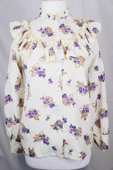 Women's vintage 1980's Val Lanne's label long sleeve button up blouse with ruffle details and pearl buttons. Cream color with all over purple floral print. 