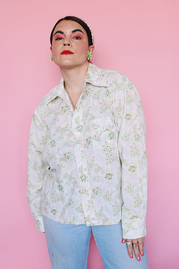 Men's or women's vintage 1970's Sutton Place label long sleeve button up shirt in white with all over green floral print. 