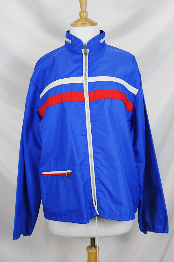 Women's or men's vintage 1970's Zody's Quality Plus, Made in Japan label long sleeve bright blue nylon zip up windbreaker with white and red trim. 