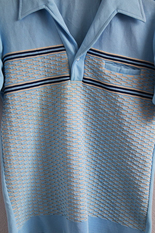 Men's or women's vintage 1970's Styled in California for JCPenney label short sleeve polo top in a light blue polyester material. Has a collar and half button closure.
