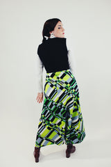 vintage long sleeve maxi dress with mock neck and attached black vest skirt bottom has green grey and black print back