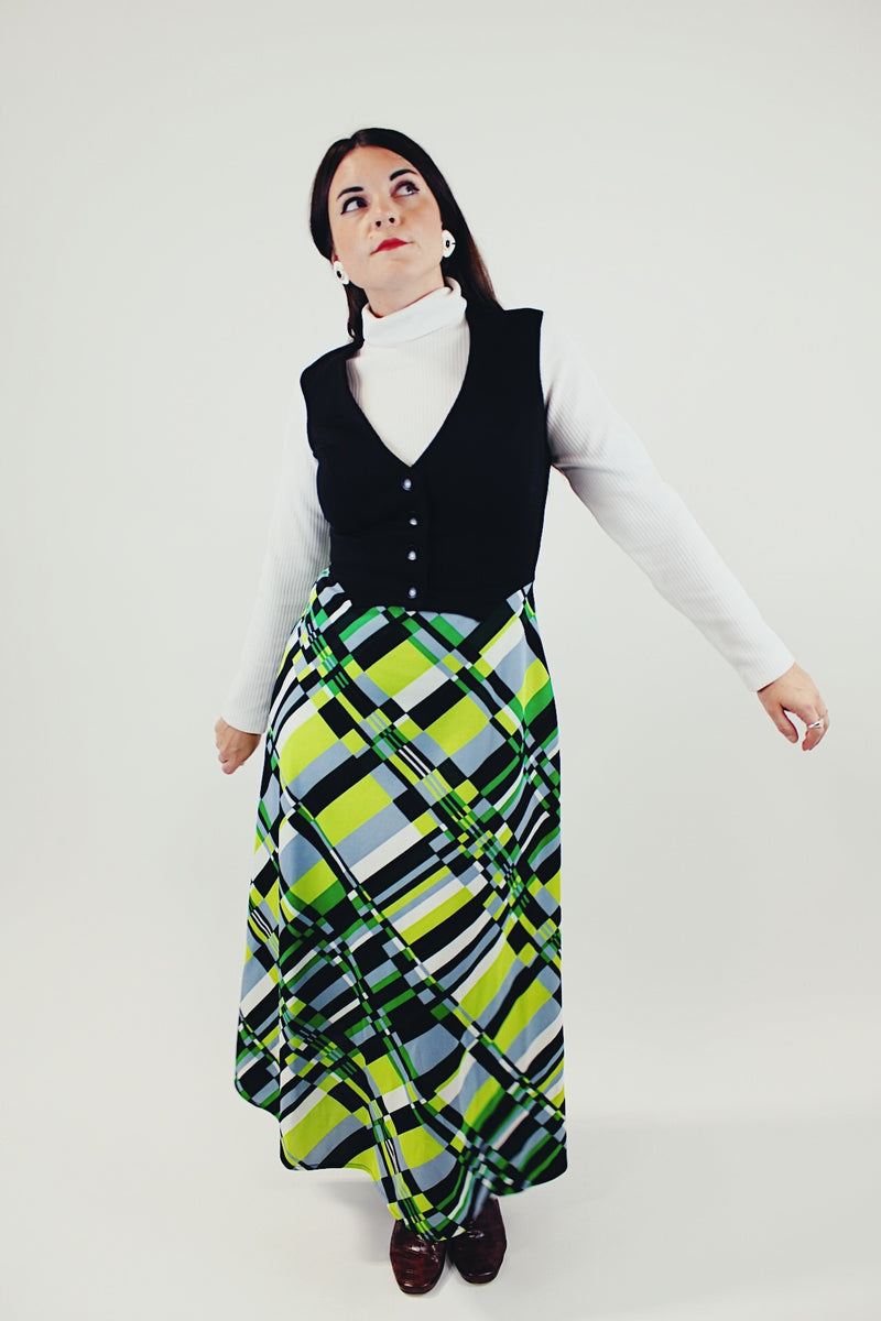 vintage long sleeve maxi dress with mock neck and attached black vest skirt bottom has green grey and black print front 