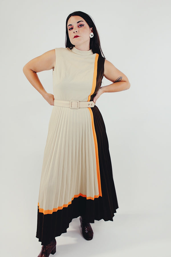 vintage sleeveless pleated dress with small mock neck and matching belt in beige, brown, and orange front