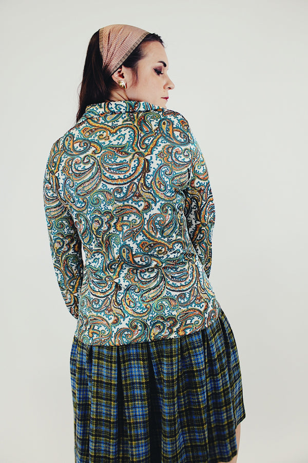 Long sleeve green and blue paisley printed blouse with double lapel back untucked