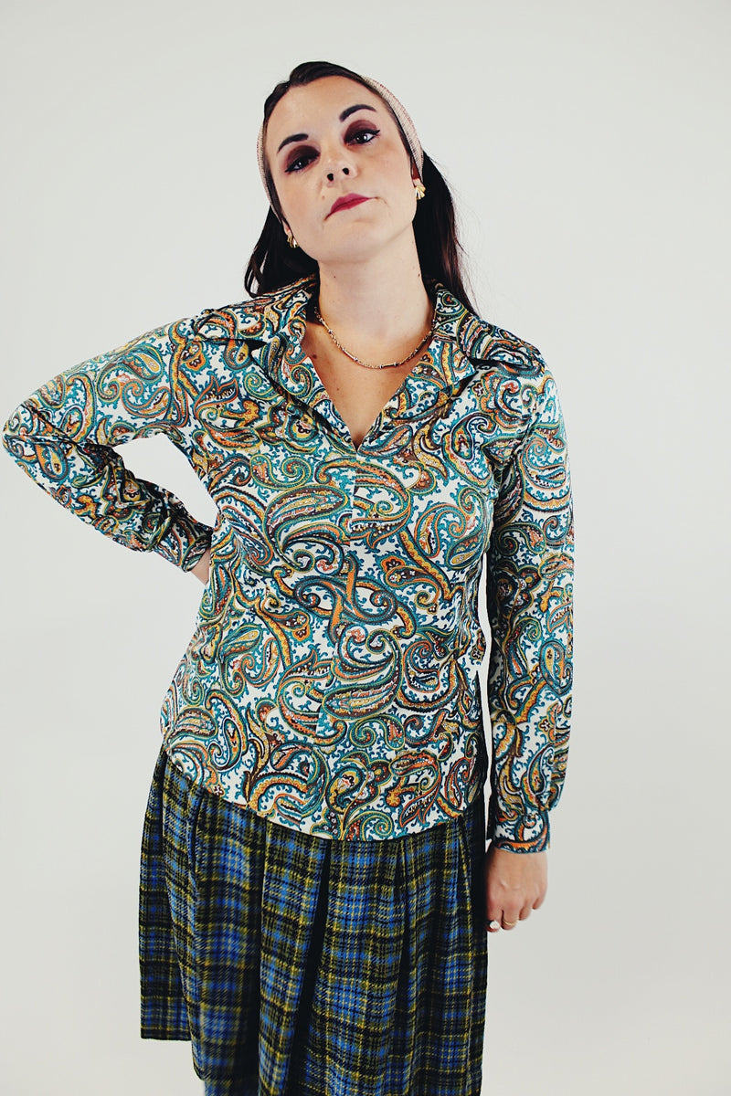 Long sleeve green and blue paisley printed blouse with double lapel front untucked
