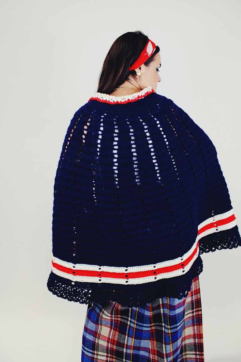 women's vintage navy crochet poncho with red and white stripes around hem with buttons and collar back