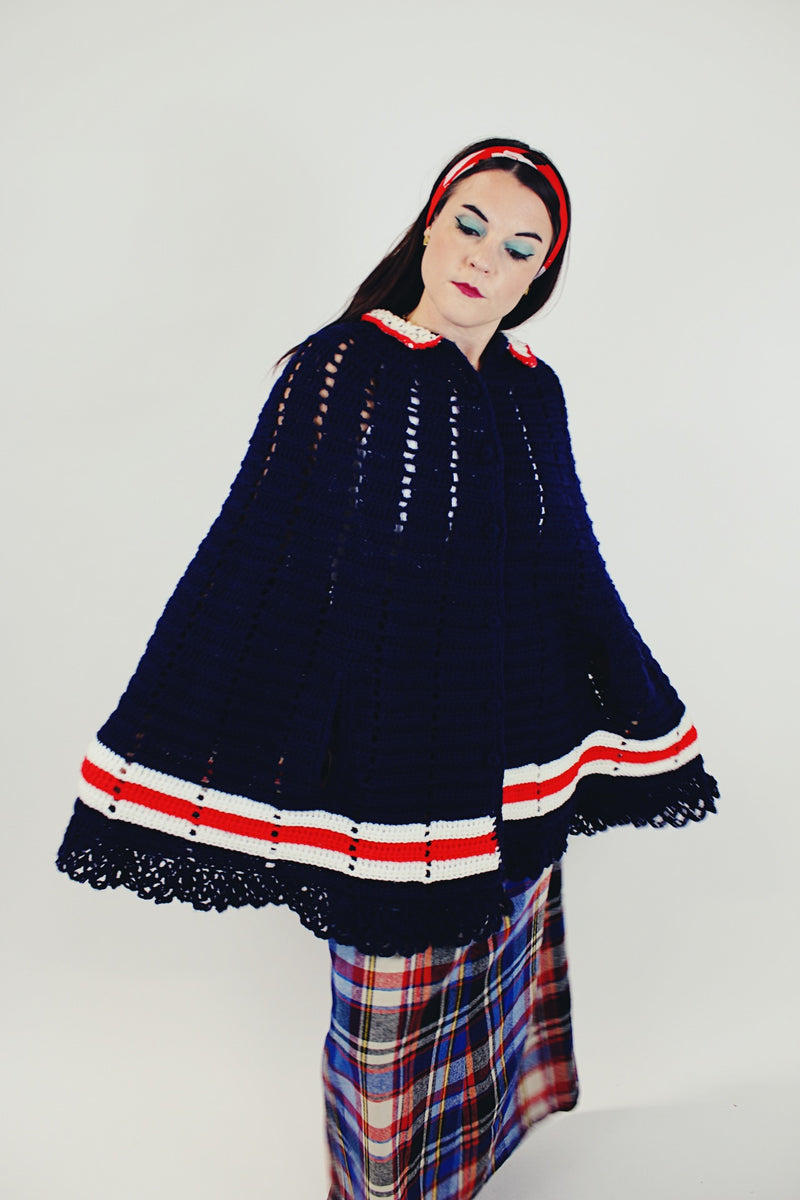women's vintage navy crochet poncho with red and white stripes around hem with buttons and collar side