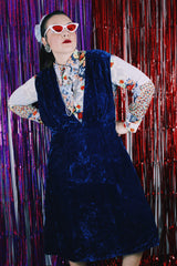 Women's vintage 1970's sleeveless dark blue crushed velvet knee length dress. Has a deep V shaped neckline in the front.