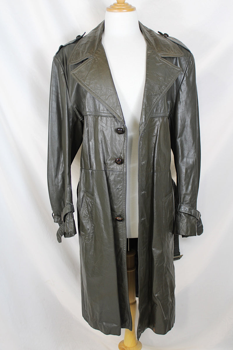 Men's or women's vintage 1970's Made in Argentina label knee length dark grey colored leather trench coat with double lapel and button closure.