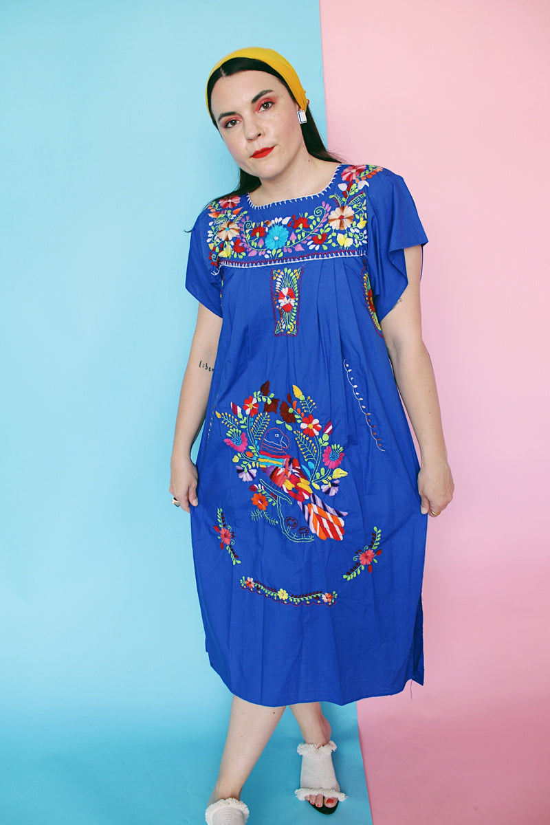 Women's vintage 1970's short sleeve bright blue cotton dress with all over multicolored floral and parrot print embroidery