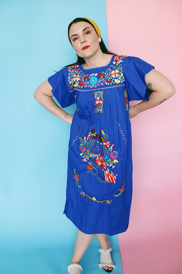 Women's vintage 1970's short sleeve bright blue cotton dress with all over multicolored floral and parrot print embroidery