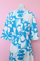 Women's vintage 1970's Polynesian Casuals, Honolulu 3/4 arm length midi length blue and white Hawaiian print dress in cotton material with cut out details on sleeves.