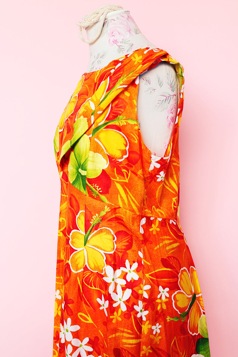 Women's vintage 1970's ears Hawaiian Fashions label sleeveless cotton material ankle length orange dress with all Hawaiian floral print.