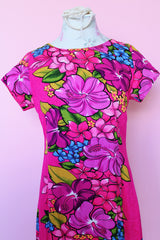 Women's vintage 1960's Skirts & Blouses Specialty Shop Honolulu label short sleeve ankle length bright pink cotton material dress with all over Hawaiian floral print.