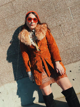 Women's vintage 1970's Leatherscapade, Made in Argentina label long sleeve brown orange genuine leather suede coat with faux fur trim and shearling liner with matching tie belt.