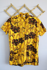 Women's vintage 1970's La Rosa, San Francisco label short sleeve button up blouse in yellow with all over brown Hawaiian print.