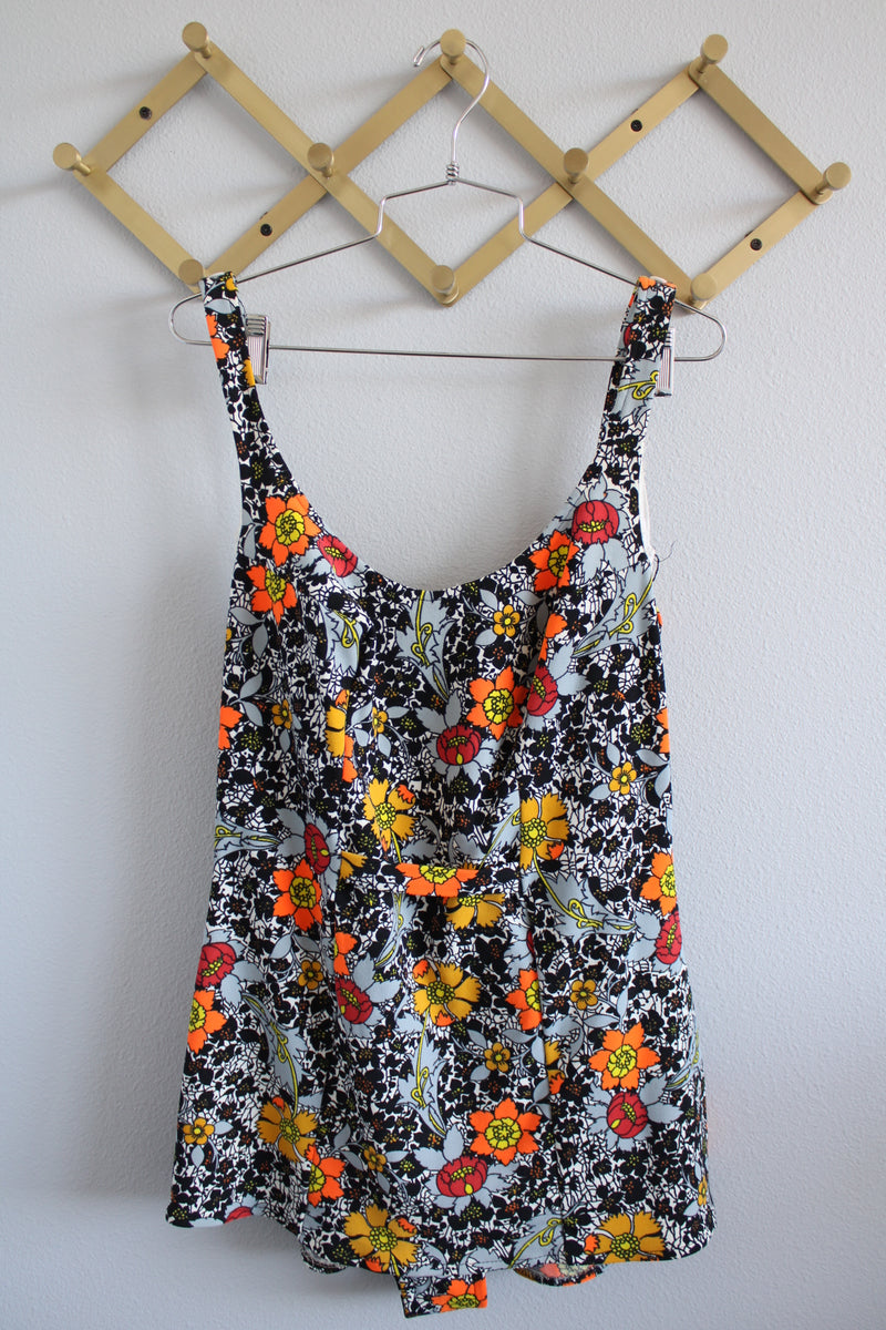 Women's vintage 1960's sleeveless one piece floral printed swimsuit in grey, black, and orange