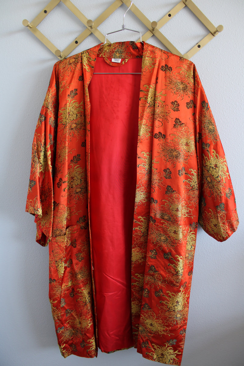 Women's vintage 1970's Made in Japan 3/4 arm length shiny satin like polyester open front kimono style robe with all over gold metallic print.