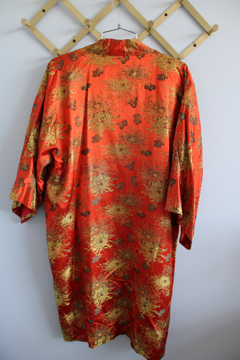 Women's vintage 1970's Made in Japan 3/4 arm length shiny satin like polyester open front kimono style robe with all over gold metallic print.