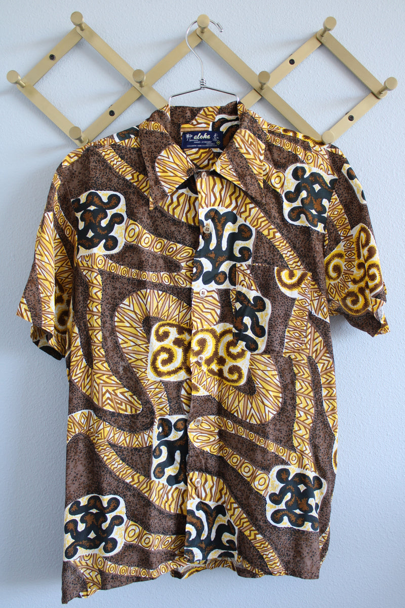 Women's or men's vintage 1970's Aloha Authentic Hand-Screened Originals label short sleeve Hawaiian print button up collared shirt in yellow, white, and brown colors.