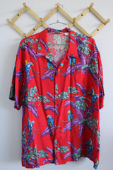 Men's vintage 1970's Michael Gerald Ltd., Hand Screened short sleeve button up shirt in an all over Hawaiian print with parrots.