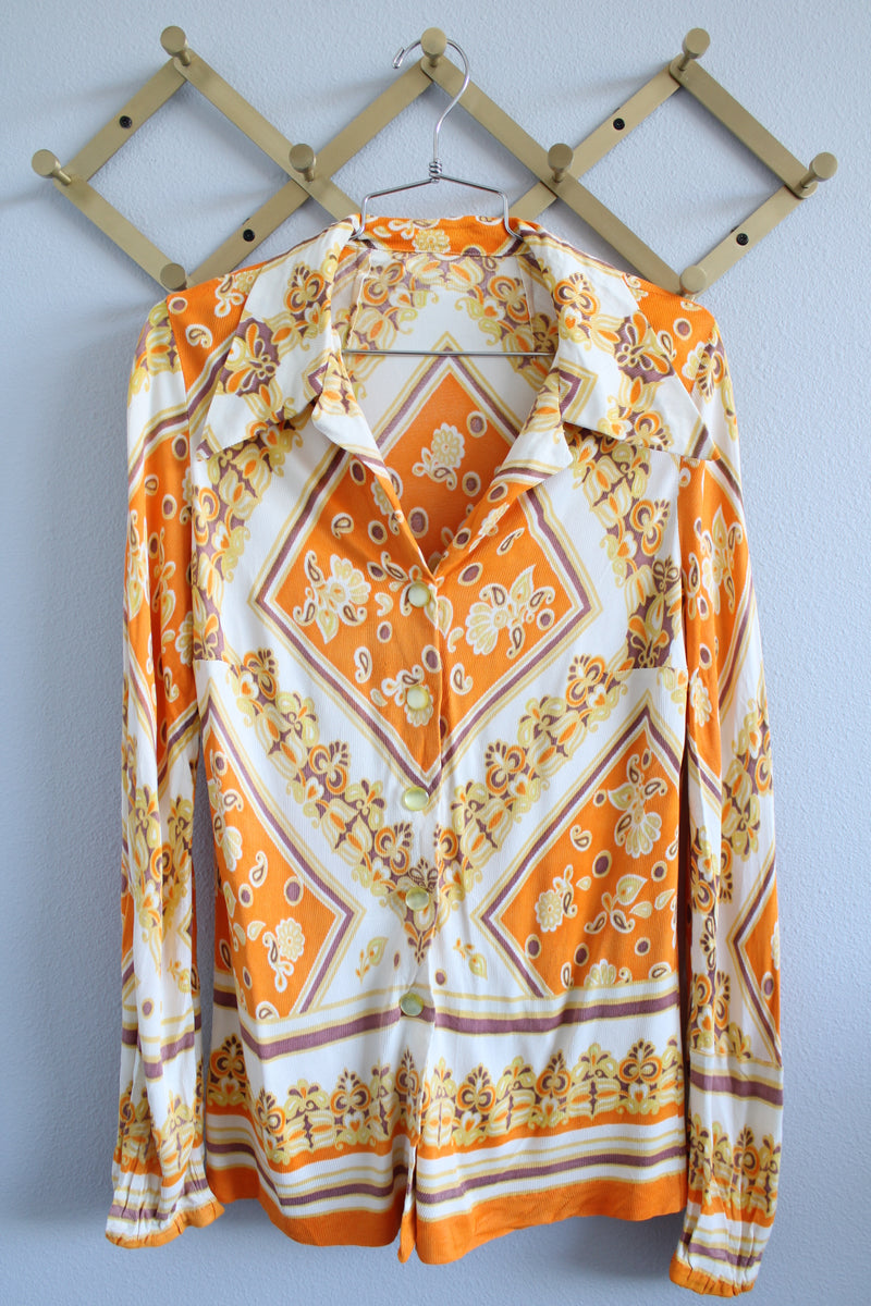 Women's vintage 1970's long sleeve button up blouse with dagger collar, darted bust, and big round clear buttons.