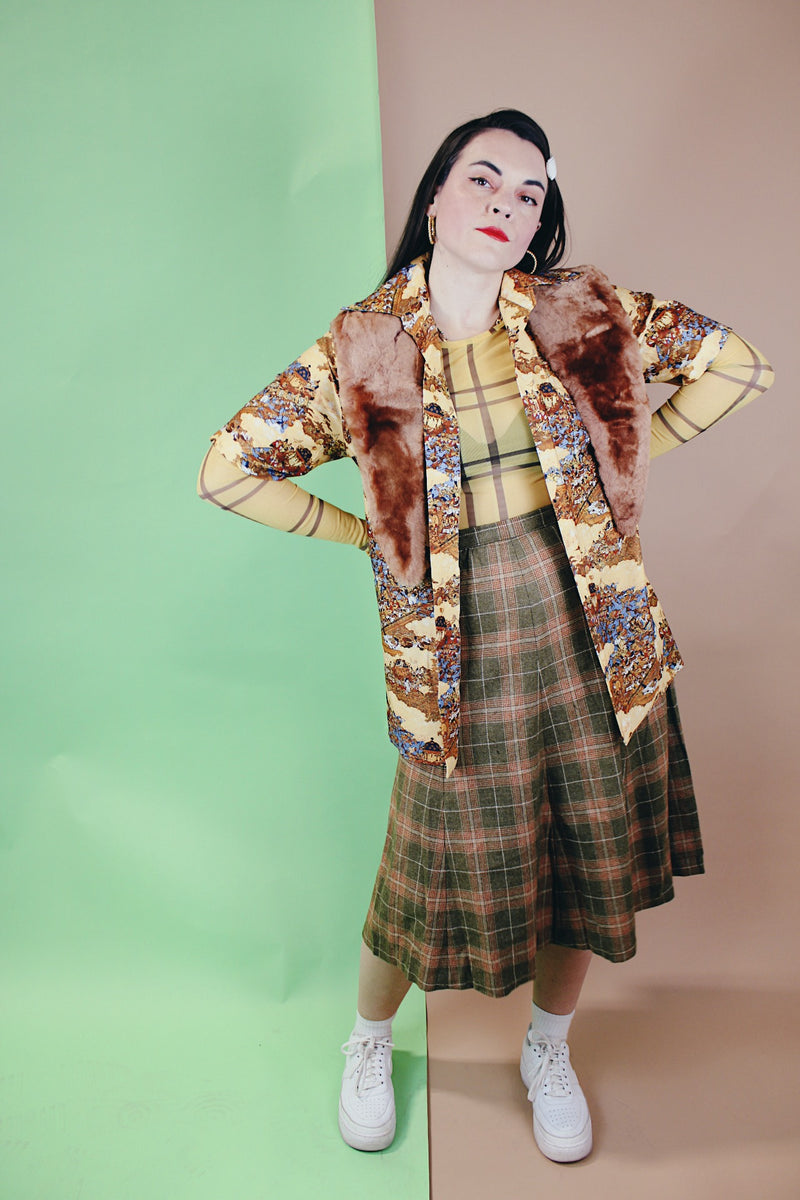 Women's vintage 1970's wool material plaid printed pleated knee length high waisted skirt. Olive green with tan, cream, and burnt orange plaid