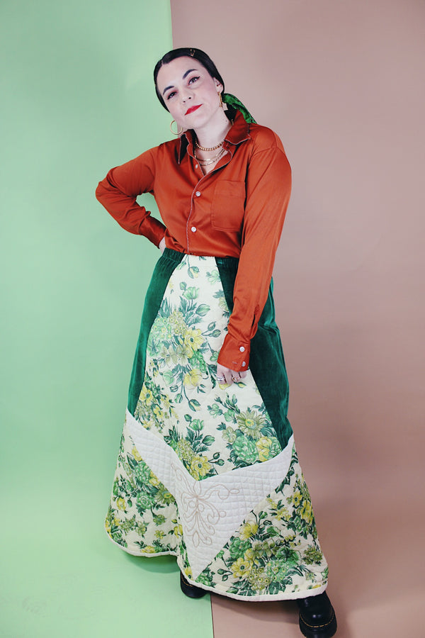 Women's vintage 1970's Chelsea Davis label a line shaped maxi skirt in a patchwork quilted print. Green velvet with white and green floral patches.