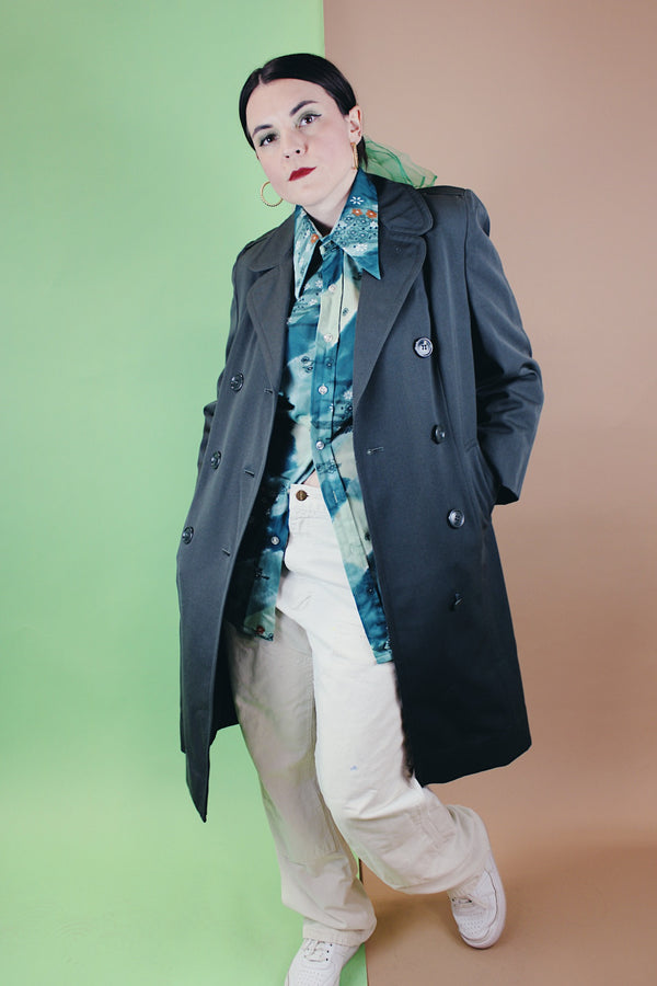 Women's vintage 1960's long sleeve cotton double breasted trench coat in a grey green color.