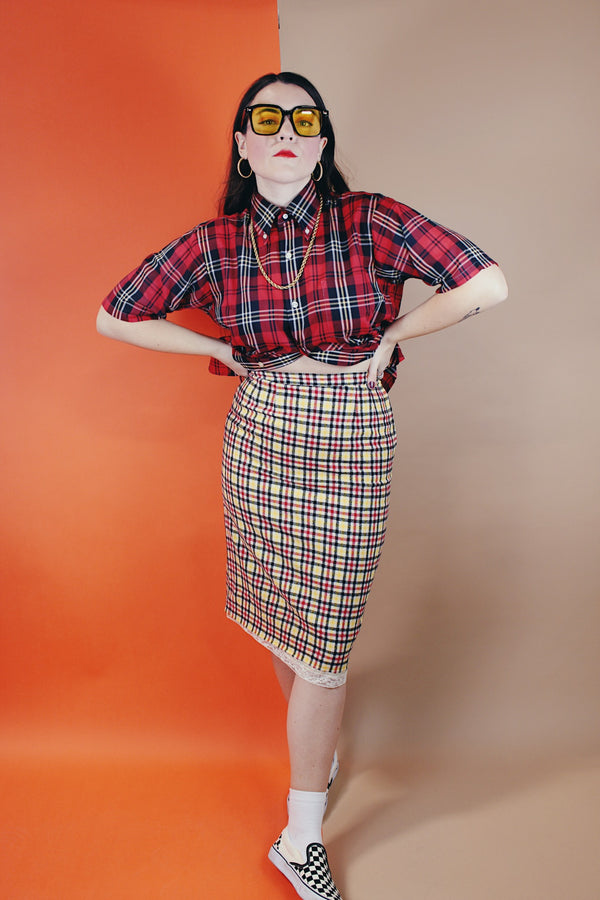 Women's vintage 1970's high waisted midi length pencil skirt in cream with yellow, red, and black plaid print in a wool material