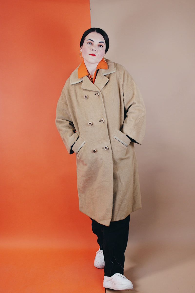 Women's vintage 1960's Dumas label 100% Mongolian camel hair coat in light tan colored with a double breasted closure, double lapel, and two pockets