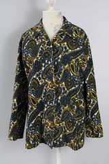 Women's vintage 1970's Hand Fashion long sleeve polyester blouse with a collar and gold buttons. Blue, white, and yellow paisley all over print.