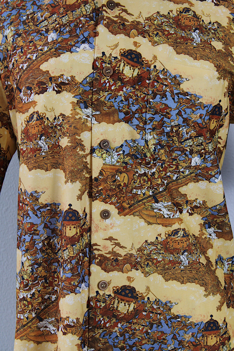 Women's or men's vintage 1970's short sleeve button up shirt with a pointy collar, brown buttons, and all over print in lightweight, soft polyester material