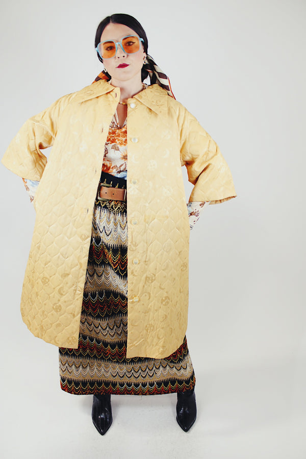 gold colored quilted duster jacket buttons up the front with collar and moon and star all over print